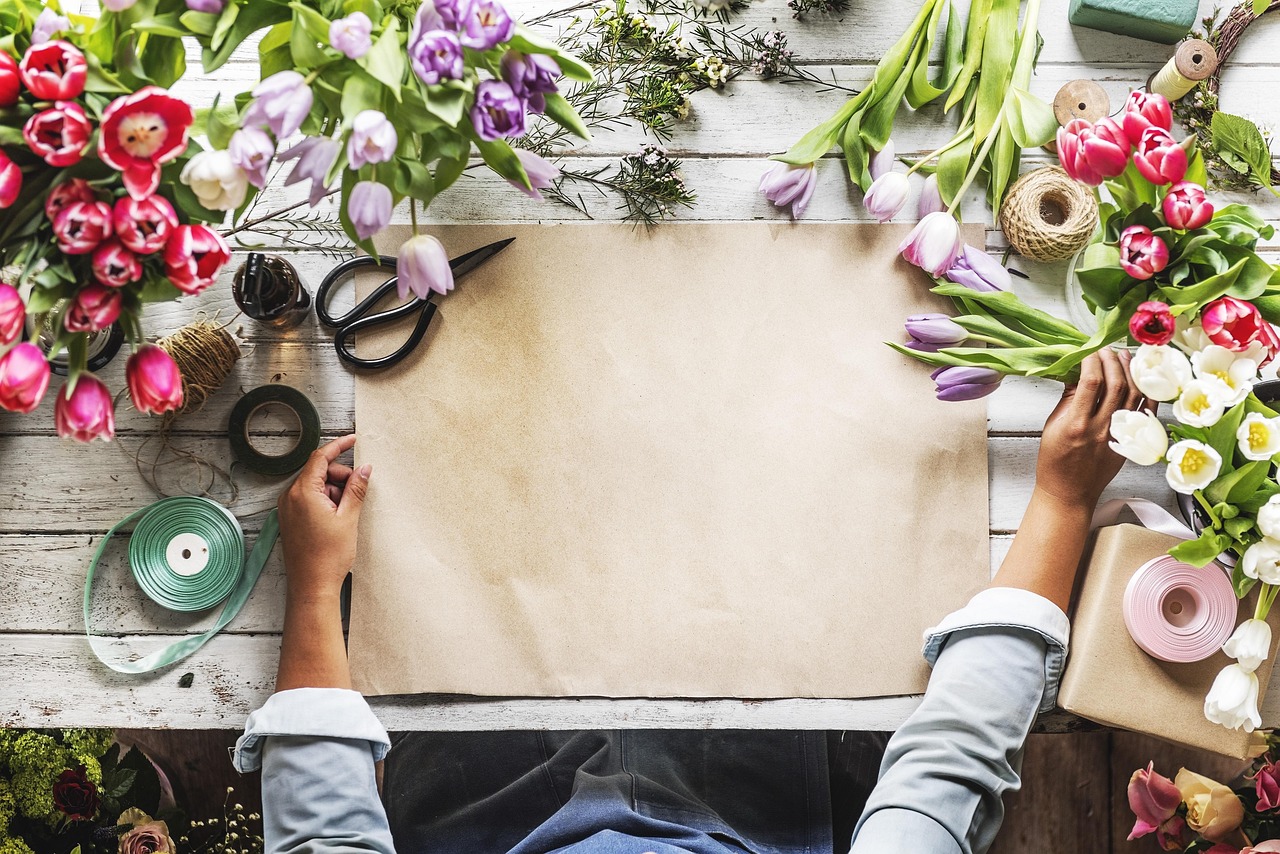 Florist's hands carefully arranging flowers